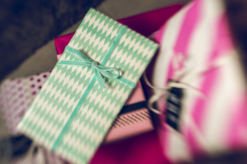 Many colorful present gifts on wrap paper
