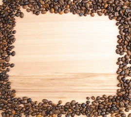 Coffee beans on wooden background, copy space