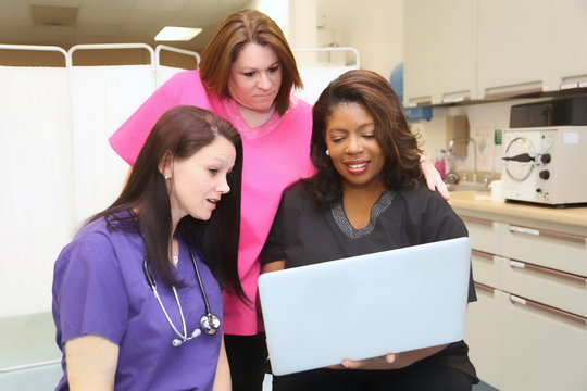 Three female healthcare professionals discussing patient diagnosis.