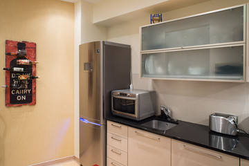 Fototapeta premium Modern studio interior in private house. Kitchen
