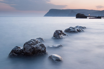 Fototapeta na wymiar Stones in the sea on a long exposure