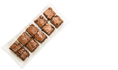 Homemade brownies in white plate over white background
