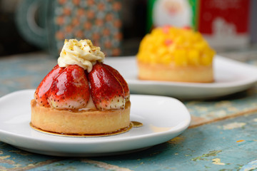 Strawberry Tart and mango Tart on a wooden table