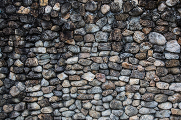 Wall paved with cobblestones background