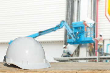 Safety helmet with over Construction site background