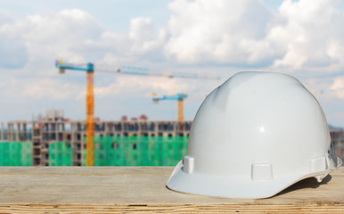 Safety helmet with over Construction site background