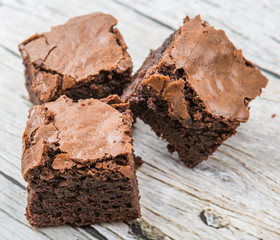 Homemade chocolate brownies over wooden background