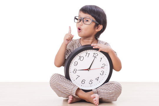 Cute boy is holding big clock 