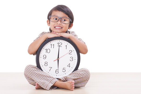 Cute boy is holding big clock 