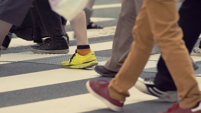 Anonymous people crossing a crosswalk in Japan, feet only