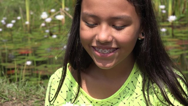 Young Girl Laughing near Pond