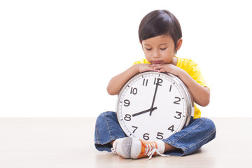 Cute boy is holding big clock 