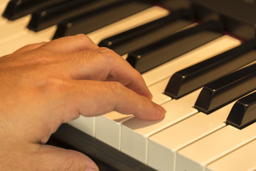 Obraz na płótnie Canvas close up of a hand on a piano