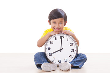 Cute boy is holding big clock 
