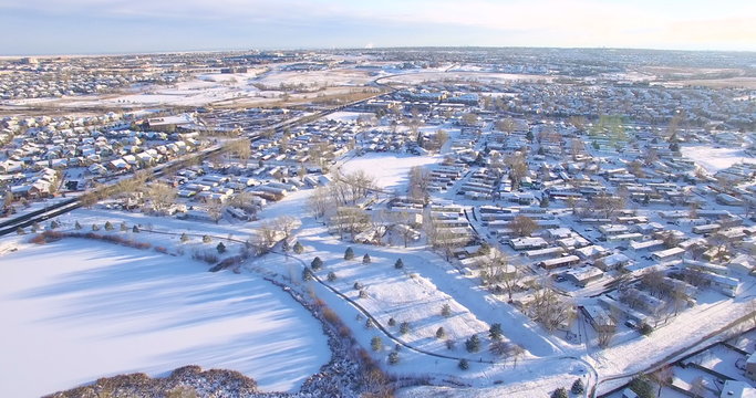 Aerial view of residential neighborhood covered in snow.