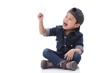 Happy boy playing with paper airplane 