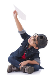 Happy boy playing with paper airplane 