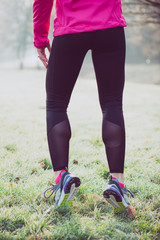 Runner woman legs on winter track, healthy lifestyle concept