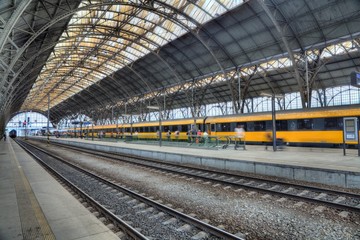 Main railway station in the Prague. Yellow train in background.