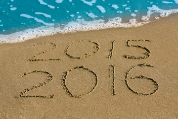 Happy New Year 2016 replace 2015 concept on the sea beach