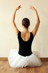 ballerina is doing exercises in ballet class sitting on the floor