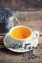 Obraz na płótnie Canvas Healthy lavender herbal tea and dry lavender in jar. Selective f