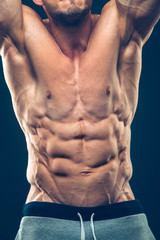 Fototapeta na wymiar Strong Athletic Man Fitness Model Torso showing six pack abs. isolated on black background with copyspace