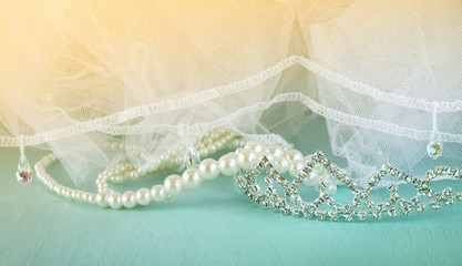 Wedding vintage crown of bride, pearls and veil. wedding concept. vintage filtered and toned image
