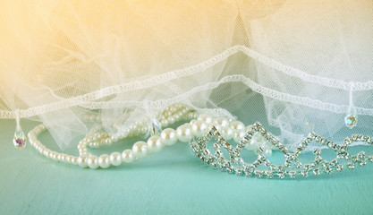 Wedding vintage crown of bride, pearls and veil. wedding concept. vintage filtered and toned image
