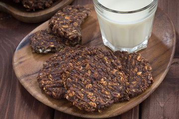 chocolate oatmeal cookies and a glass of milk, top view