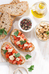 ciabatta with tomatoes and marinated feta, top view vertical