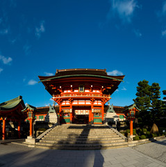 A giant torii gate in front of the Romon Gate at Fushimi Inari 