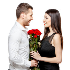 Young beautiful couple with flowers isolated on white