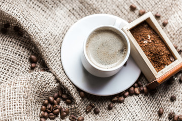 Coffee grains and coffee cup
