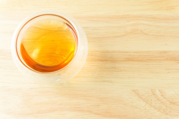 transparent cup of tea on wood background