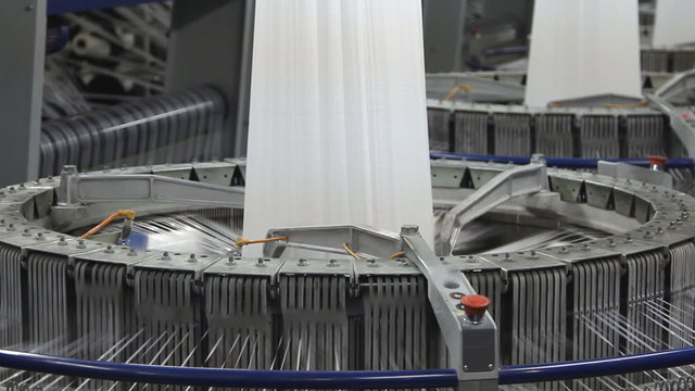 Textile industry - yarn spools on spinning machine in a factory