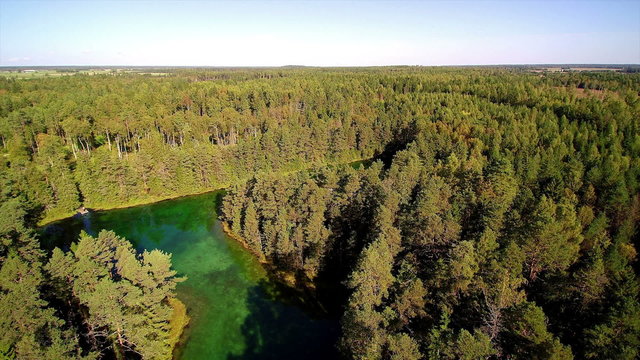 Aerial view of the Antu lake in Laane-Virumaa Estonia. There is also a well in the middle of the forest with lots of trees in it
