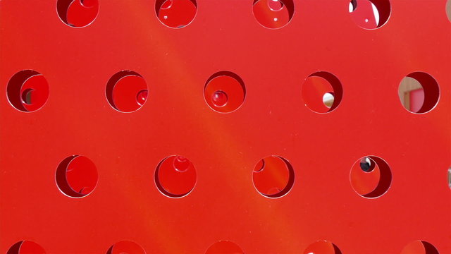 Big red standee with holes moving.
