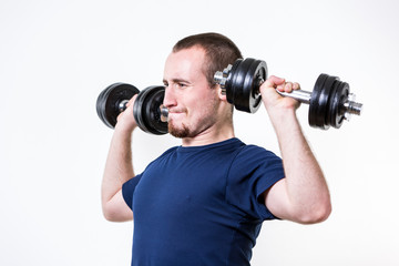 Fototapeta na wymiar Close up of young man lifting weights over white background