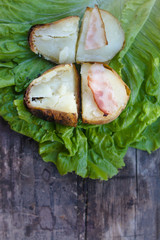 fried potato with fried bacon on fresh salad
