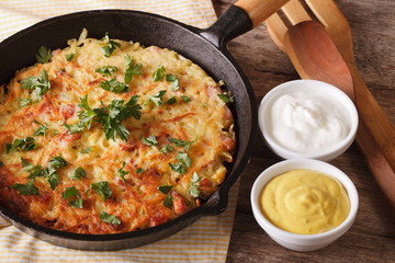 Homemade Potato pancakes with herbs close-up in a pan. horizontal
