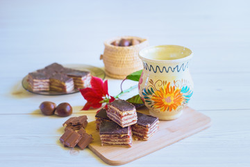 Gerbeaud dessert with chocolate and mug of milk