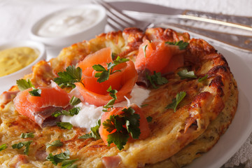 Potato Fritters with salmon on a plate close-up. horizontal
