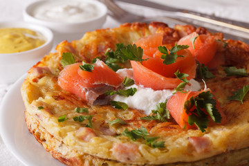 Potato pancakes with smoked salmon on a plate close-up. horizontal
