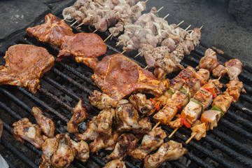 various meat chicken wings steaks grilled on brazier