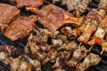 various meat chicken wings steaks grilled on brazier