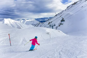 Fotobehang Girl skier in winter resort © Max Topchii