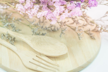 Wooden set of food utensil and static flower