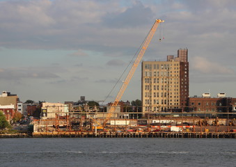 Industrial Crane at Building Site with River in Foreground
