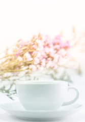 White mug cup and static flower